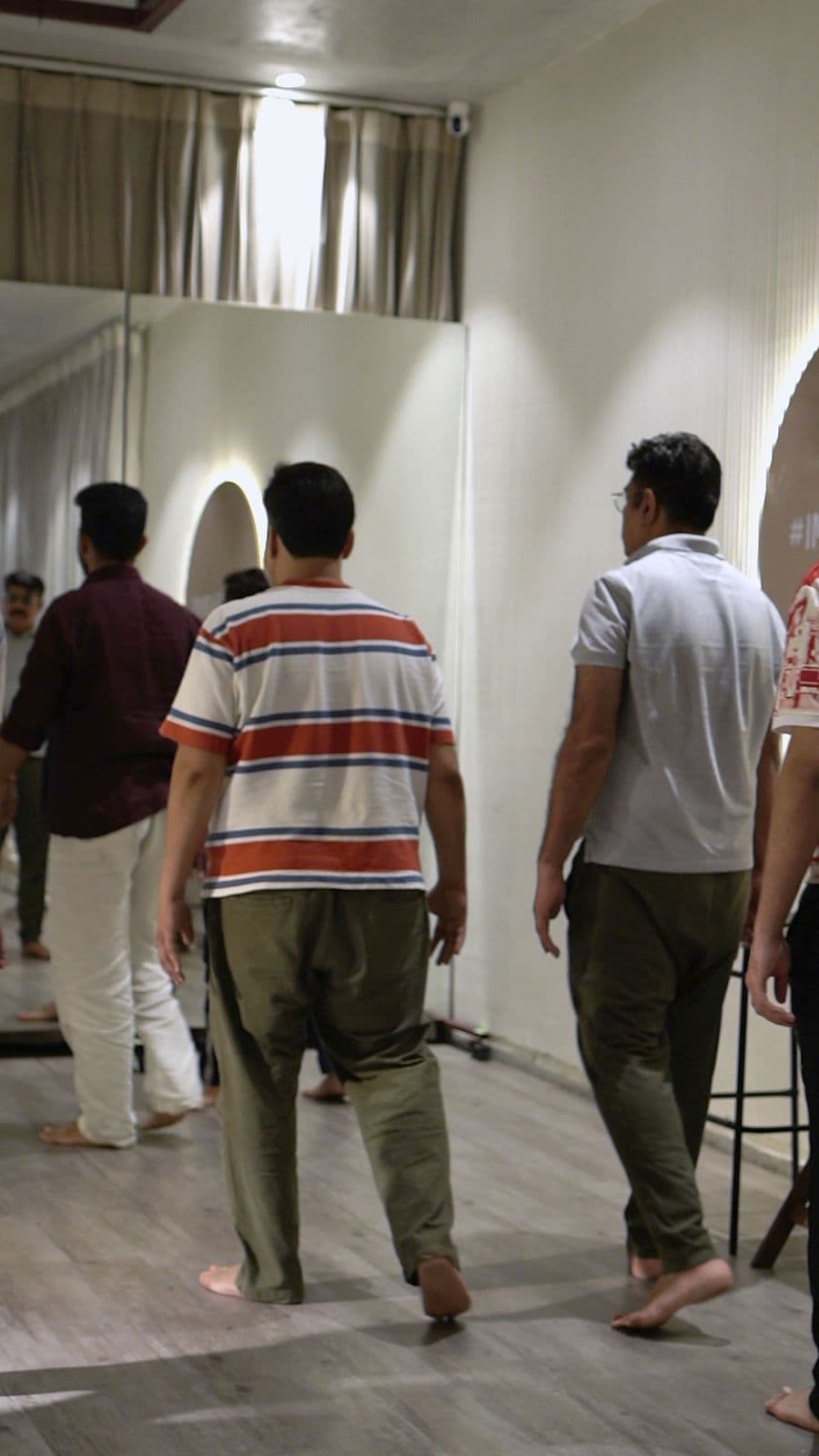 Participants walking slowly across the studio floor