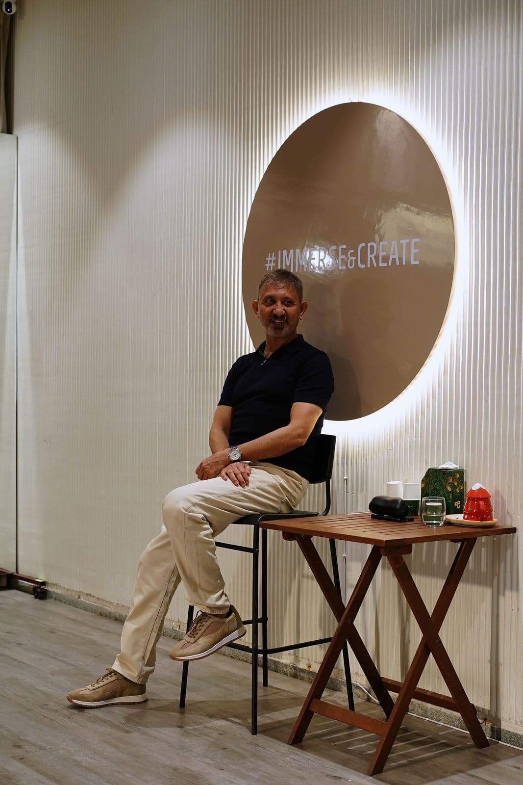 Neeraj Kabi seated on a stool, taking questions