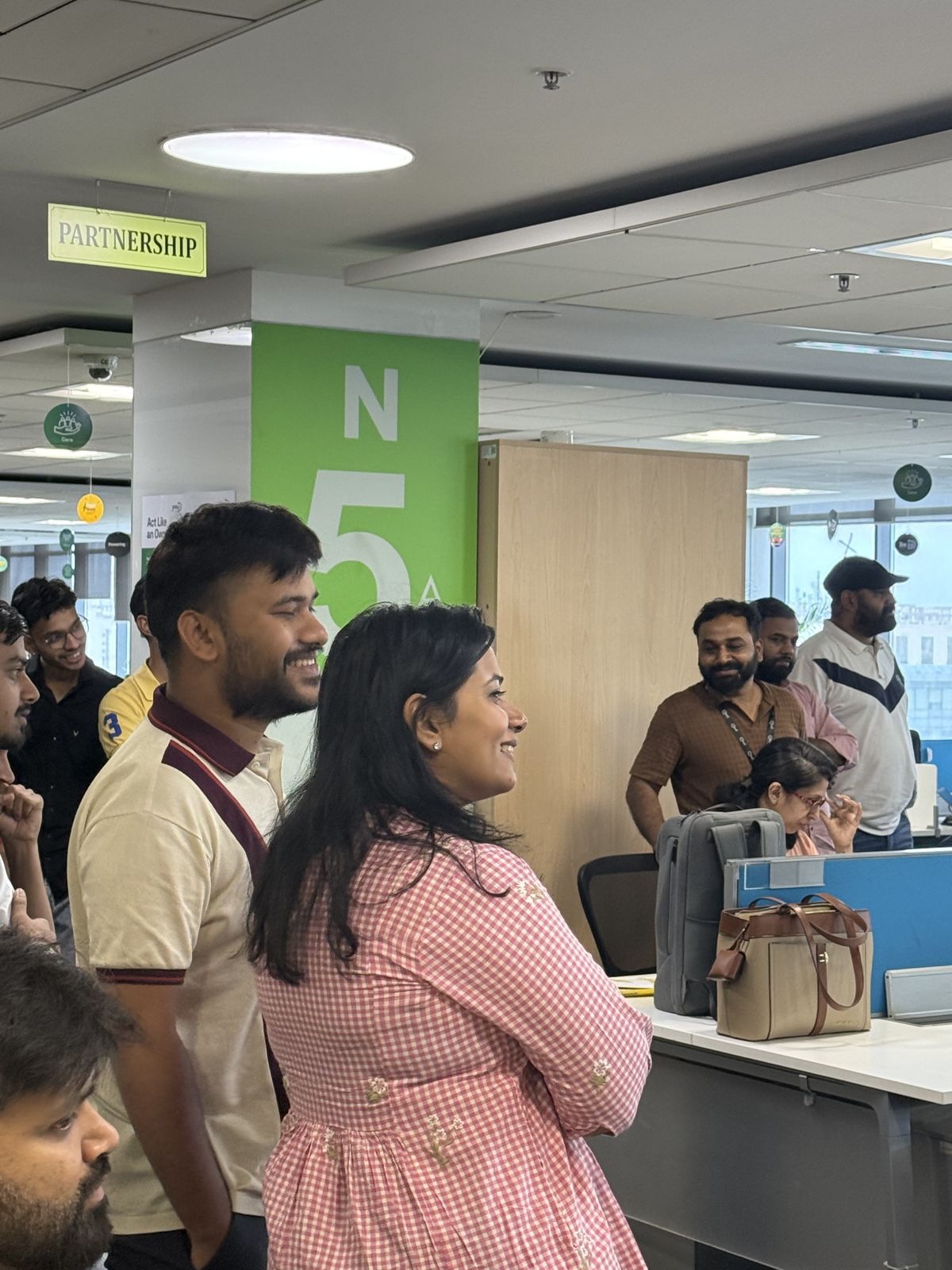 Two employees laughing at an office floor performance