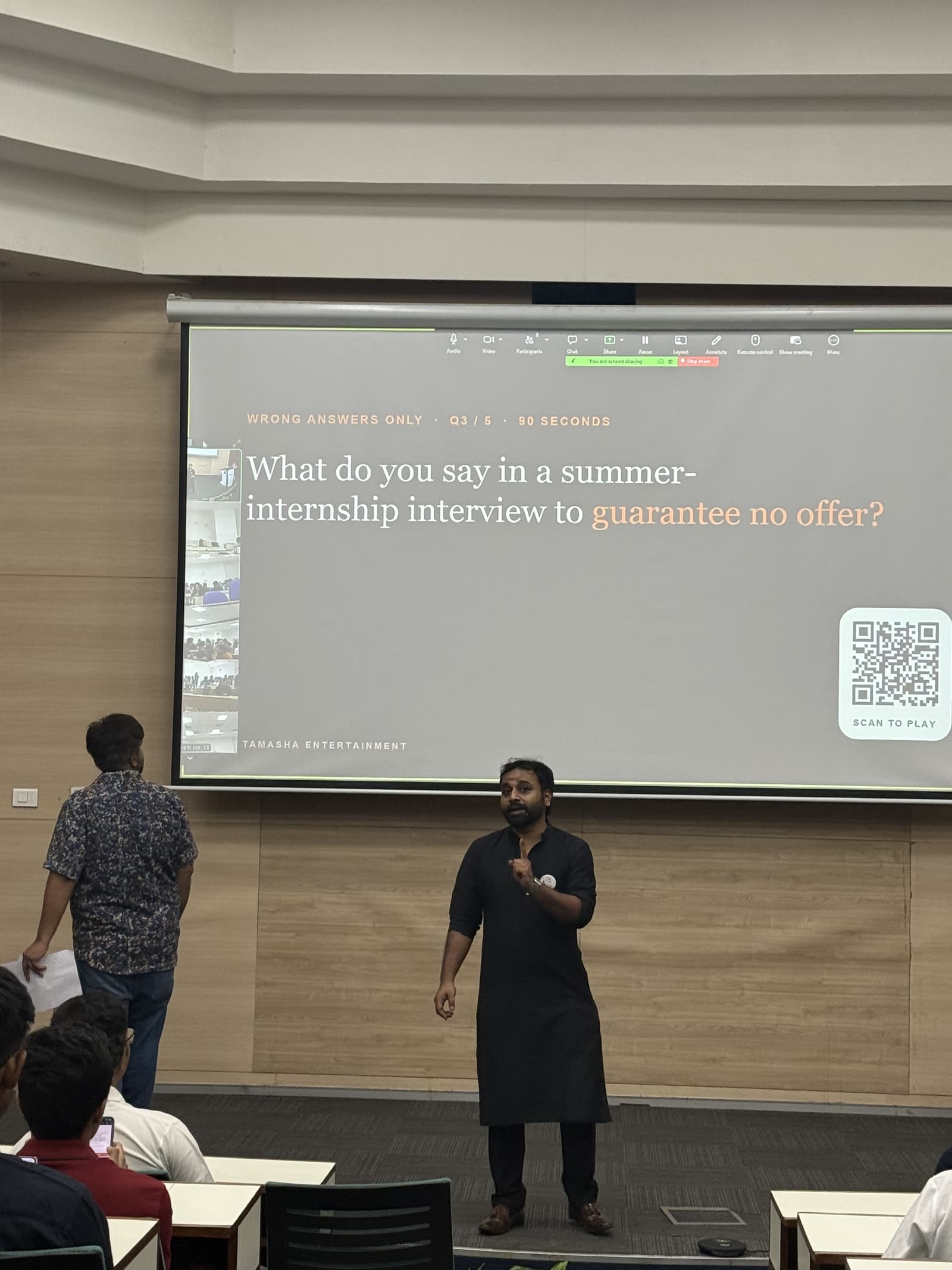 A Wrong Answers prompt on the big screen at MDI Gurgaon, with a QR code to join